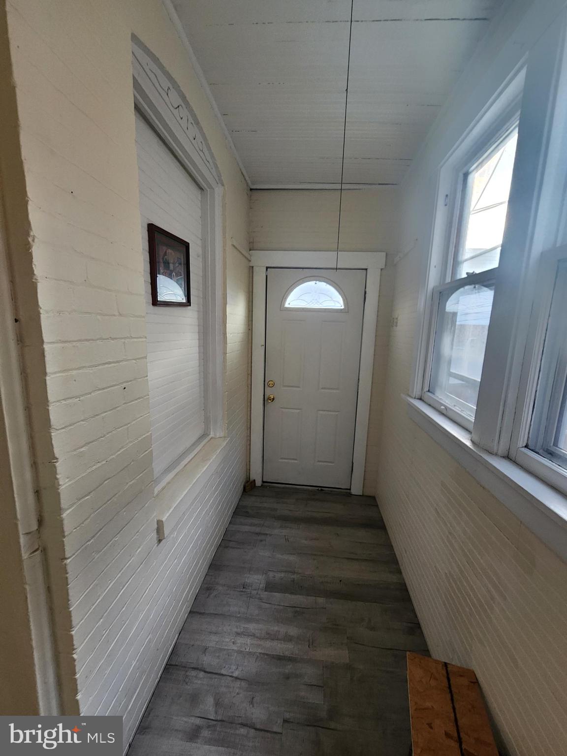 105 Park Street Cumberland, MD 21502 - Photo 7 of 18 a view of a hallway with wooden floor and staircase
