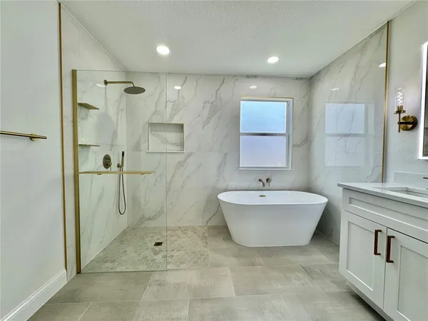 a bath room with a sink mirror and a shower