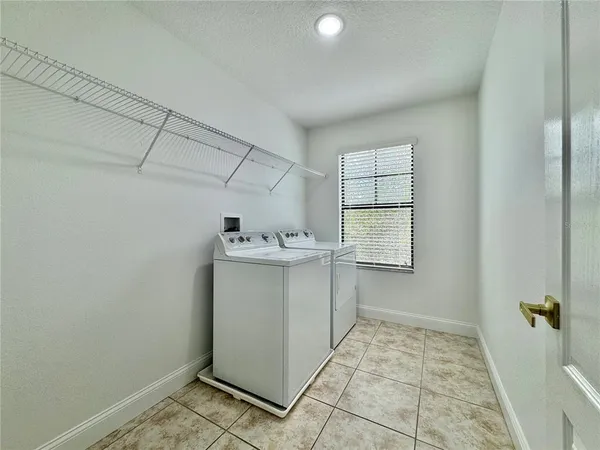a utility room with a sink dryer and washer