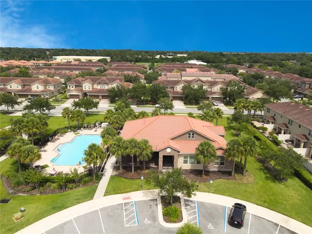 an aerial view of residential houses with outdoor space and river