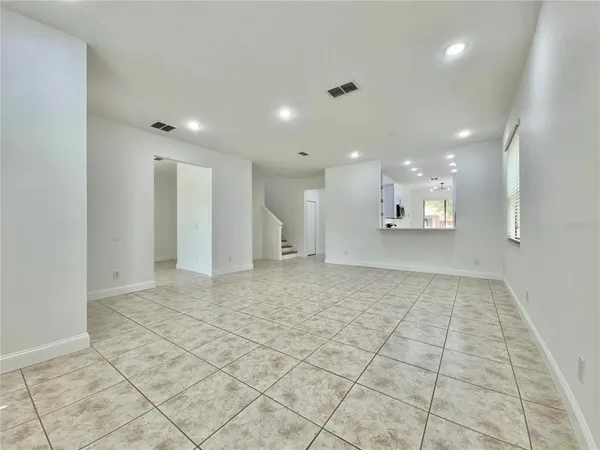 a view of an empty room and a bathroom