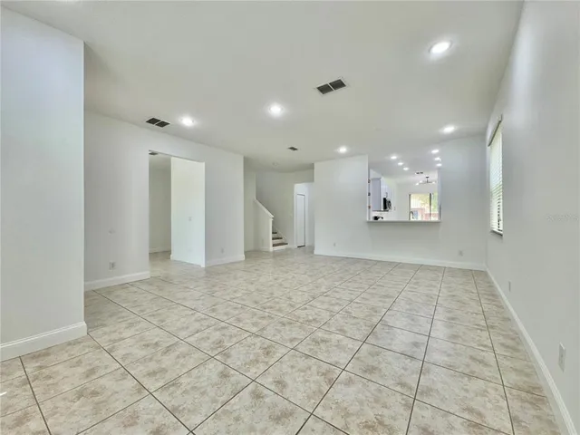 a view of an empty room and a bathroom