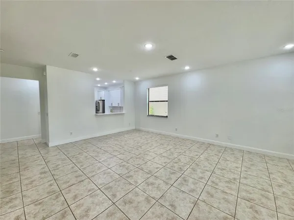 a view of an empty room and a window