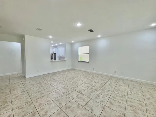 a view of an empty room and a window