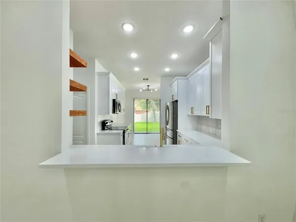 a view of a living room and kitchen