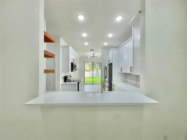 a view of a living room and kitchen