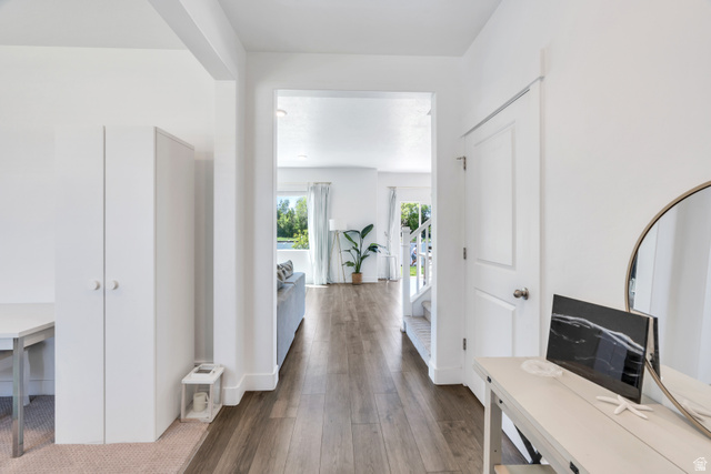 646 South Meade Street Mapleton, UT 84664 - Photo 9 of 46 Bright interior hallway featuring wood-finish flooring, white walls, and a white paneled door