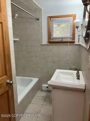 a bathroom with a sink a bath tub and a toilet