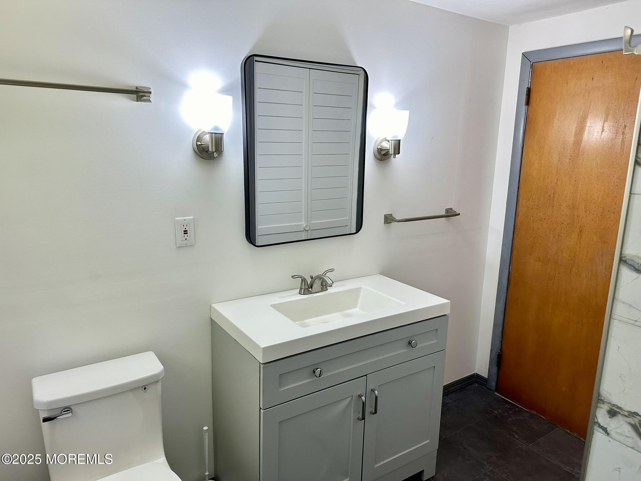 135 South Main Street Barnegat, NJ 08005 - Photo 12 of 35 a bathroom with a sink a toilet and mirror