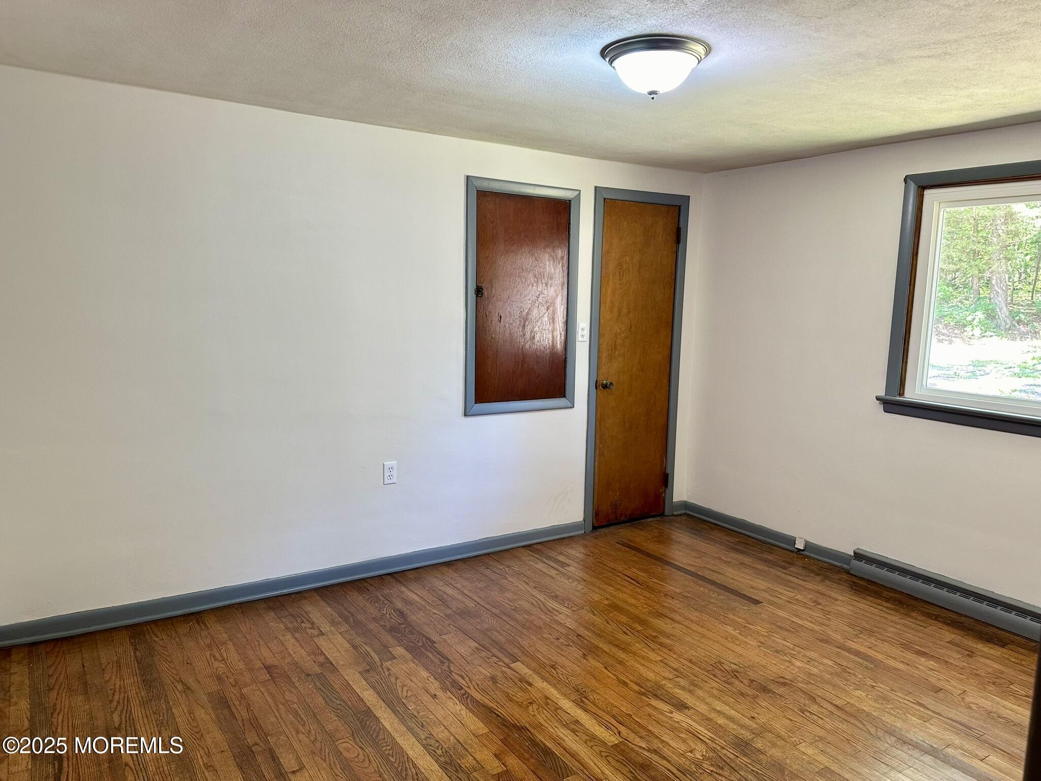 135 South Main Street Barnegat, NJ 08005 - Photo 16 of 35 an empty room with wooden floor and windows