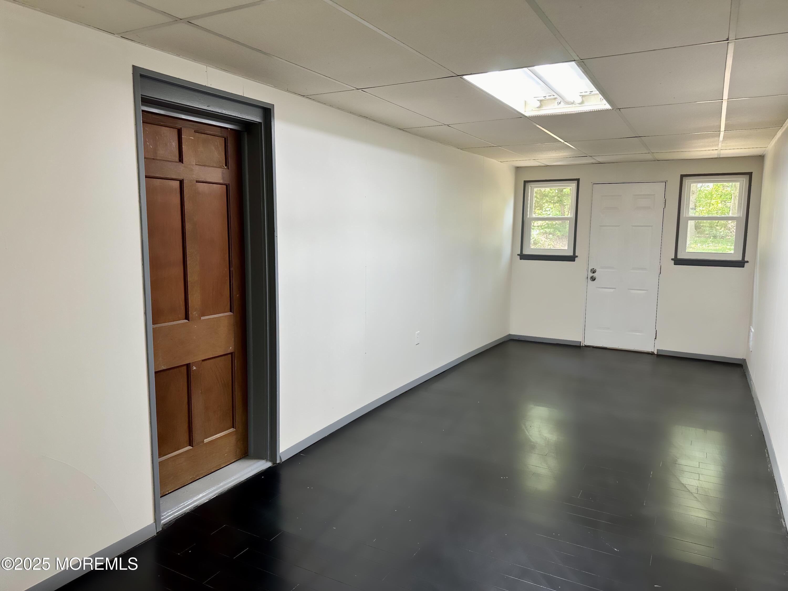 135 South Main Street Barnegat, NJ 08005 - Photo 17 of 35 an empty room with wooden floor and windows