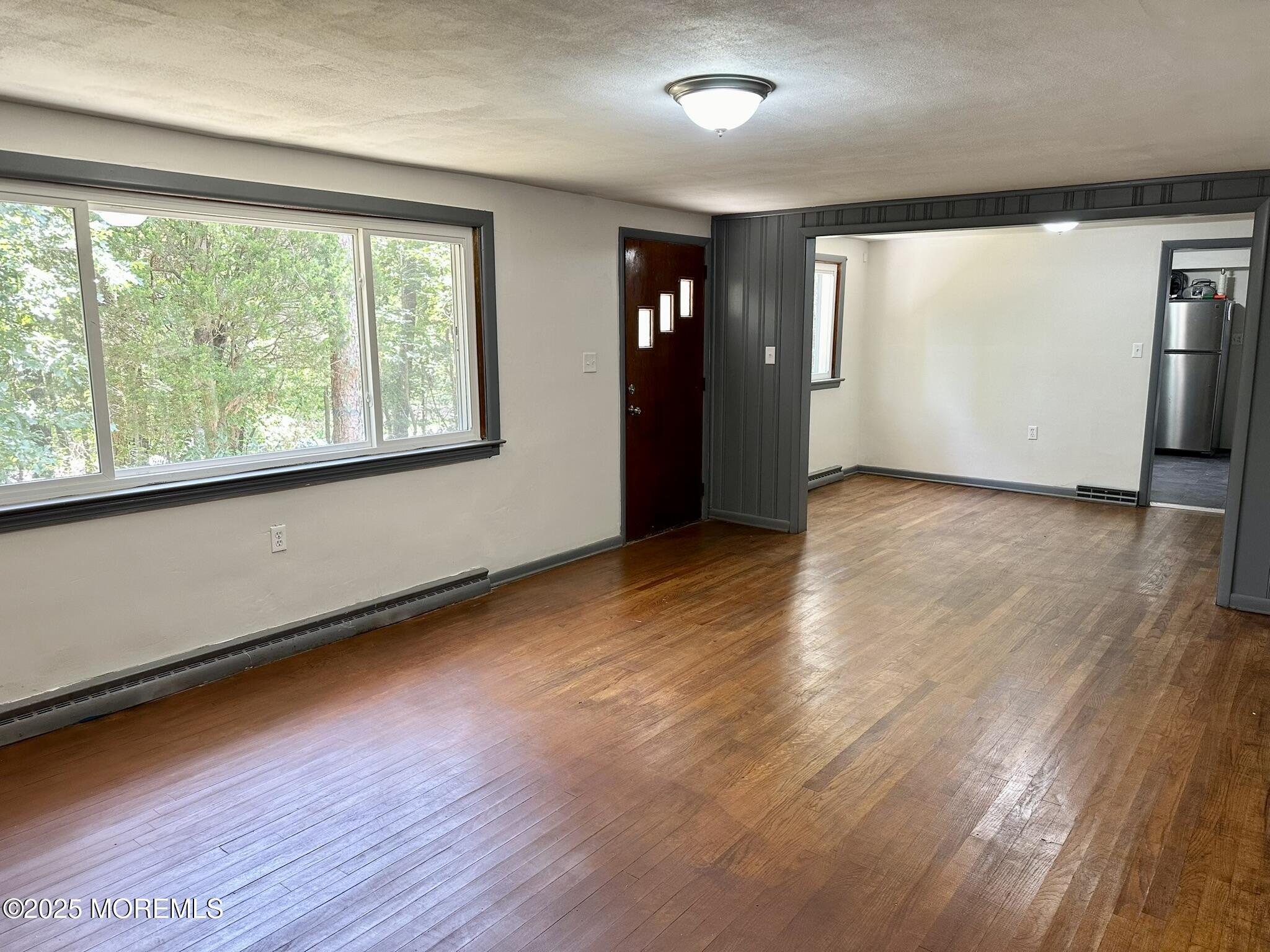 135 South Main Street Barnegat, NJ 08005 - Photo 4 of 35 an empty room with wooden floor and windows