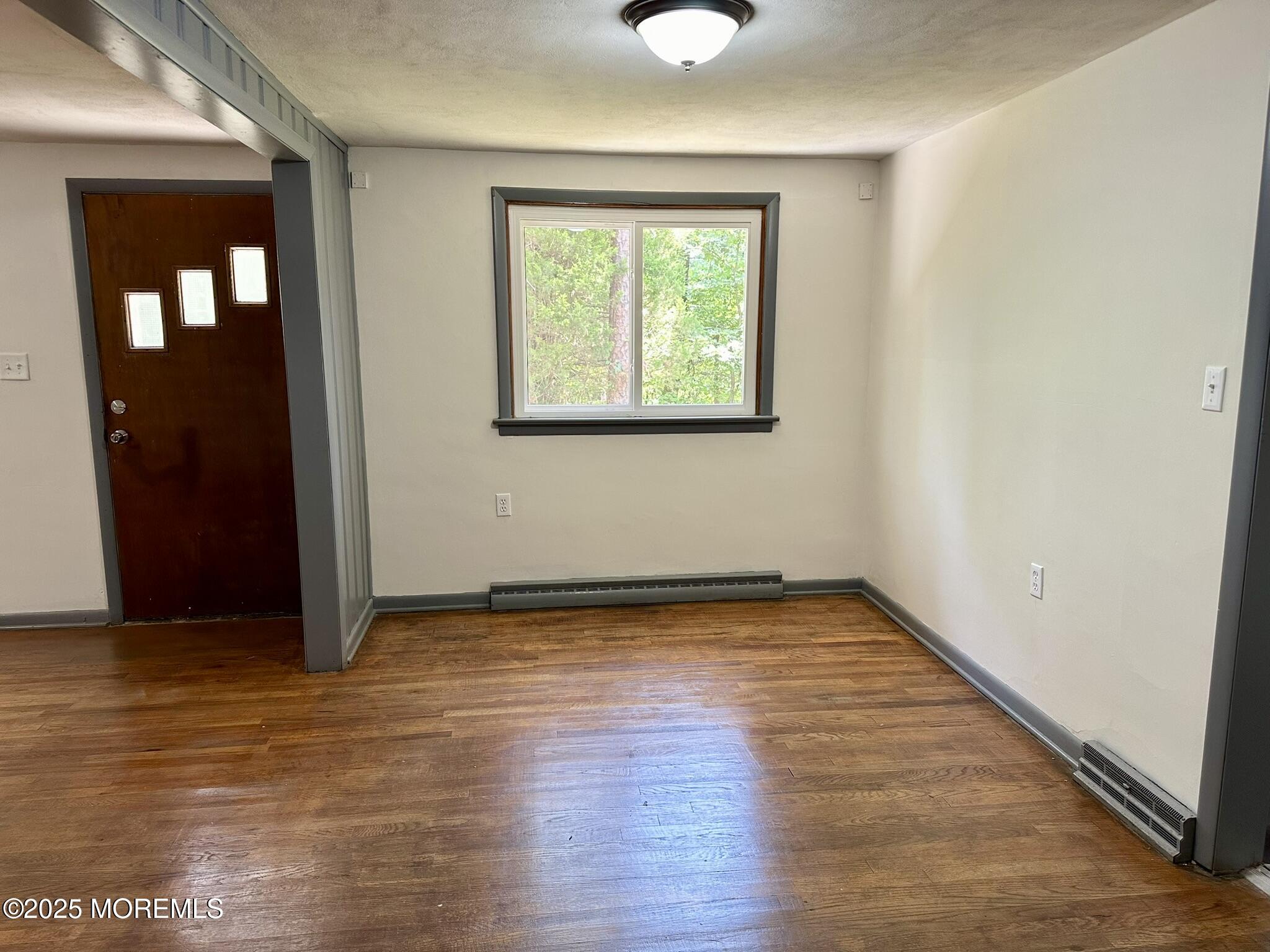 135 South Main Street Barnegat, NJ 08005 - Photo 5 of 35 an empty room with wooden floor and windows