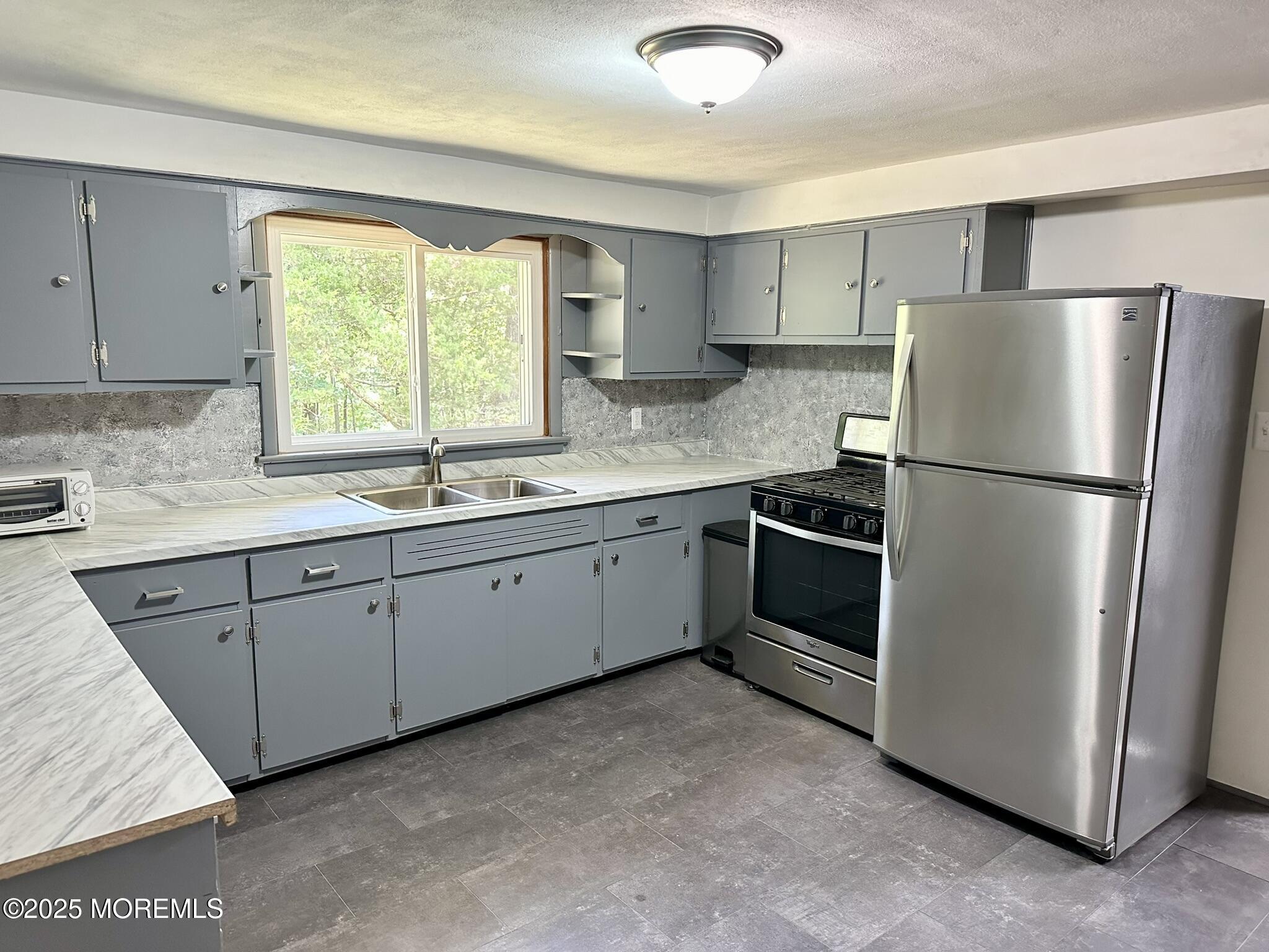 135 South Main Street Barnegat, NJ 08005 - Photo 6 of 35 a kitchen with a refrigerator sink and cabinets
