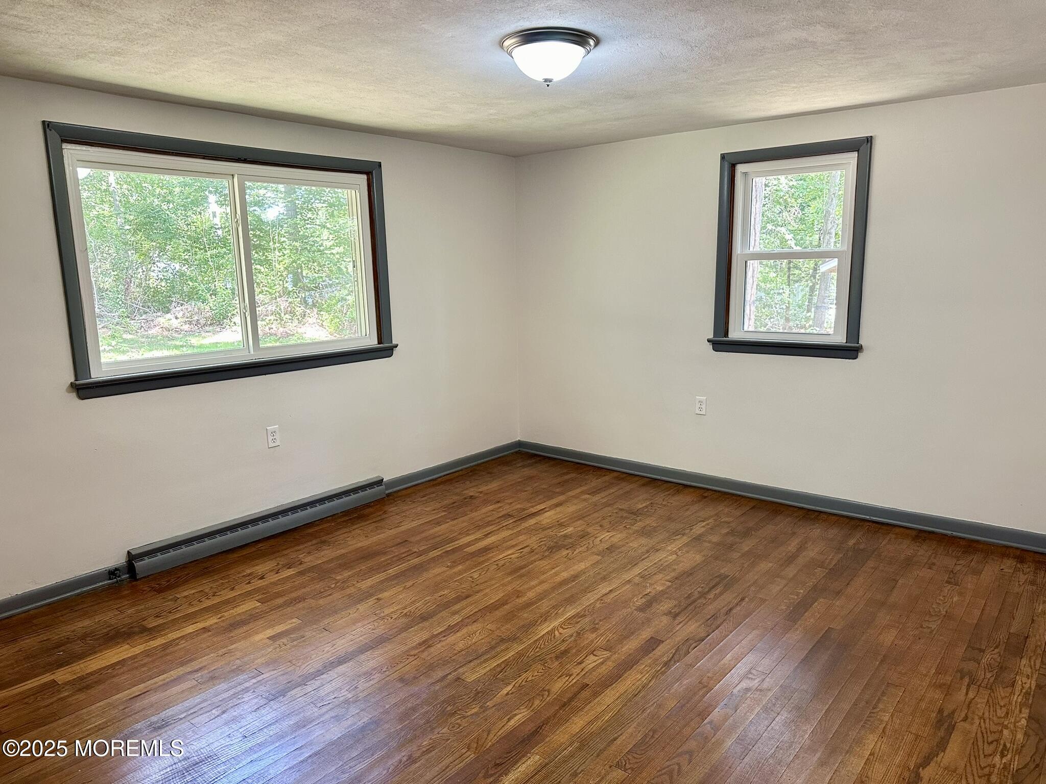 135 South Main Street Barnegat, NJ 08005 - Photo 10 of 35 a view of an empty room with wooden floor and a window