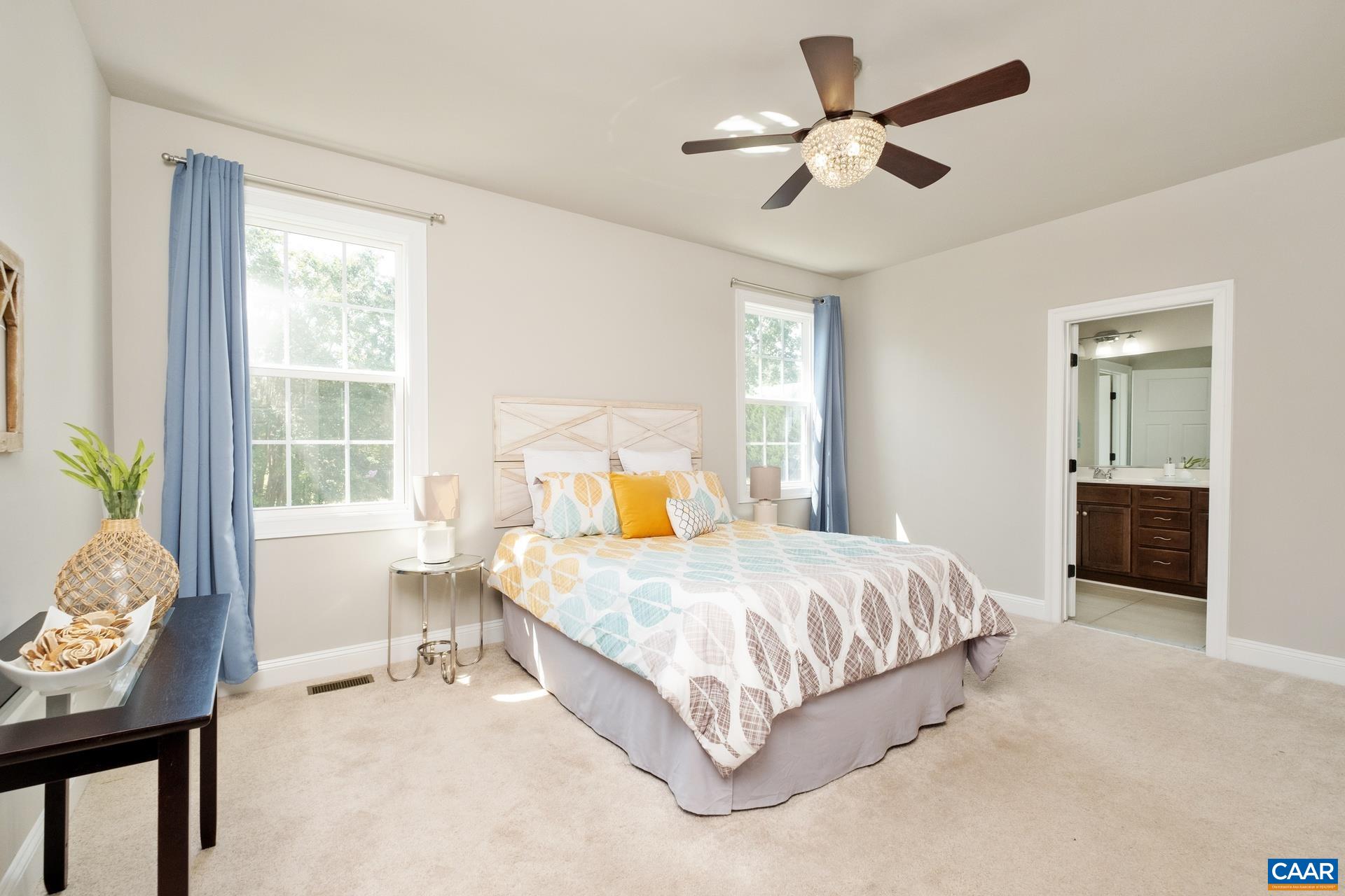 2104 Avinity Loop Charlottesville, VA 22902 - Photo 19 of 45 a bedroom with a bed and a chandelier