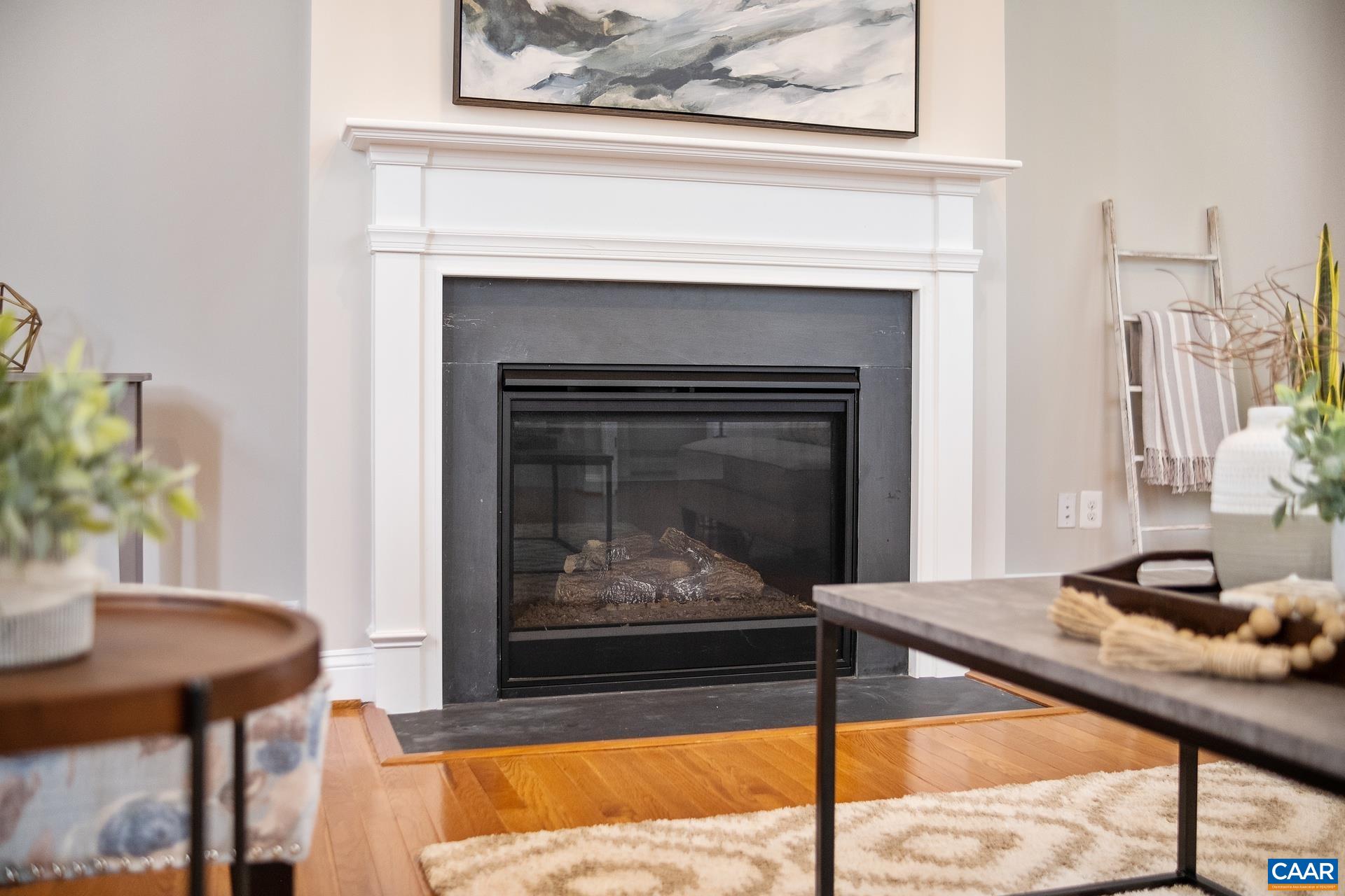 2104 Avinity Loop Charlottesville, VA 22902 - Photo 5 of 45 a living room with a fireplace and a table