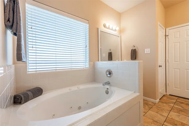 a bathroom with a bathtub and a window