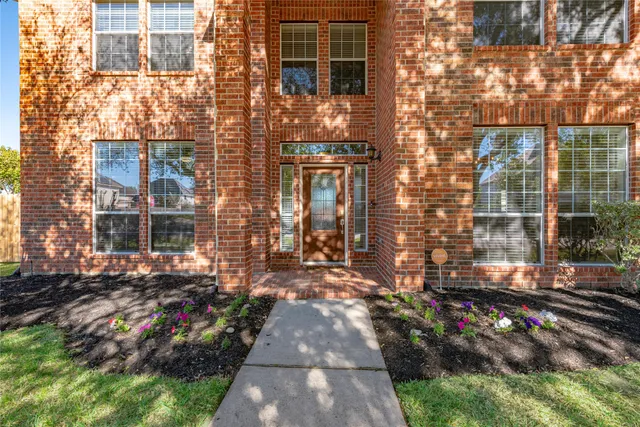 a view of a brick house with many windows