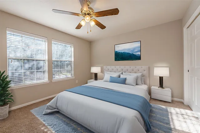 a spacious bedroom with a large bed and a window