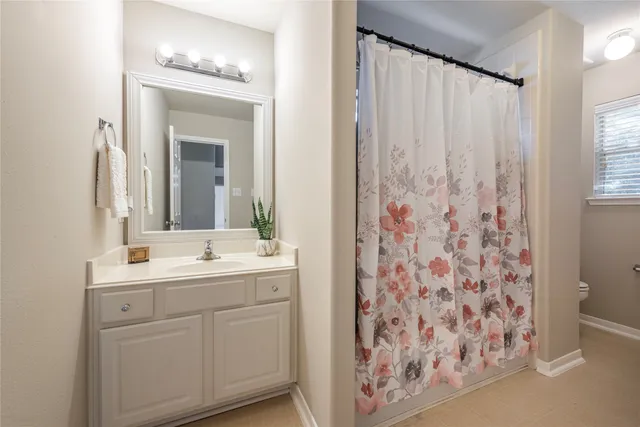 a bathroom with a double vanity sink mirror and