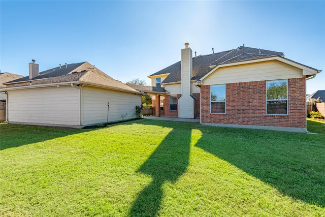 a view of a house with a backyard