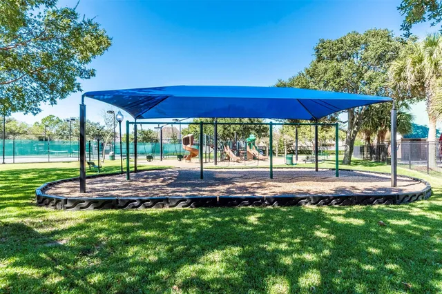 a view of yard with a table and table under an umbrella
