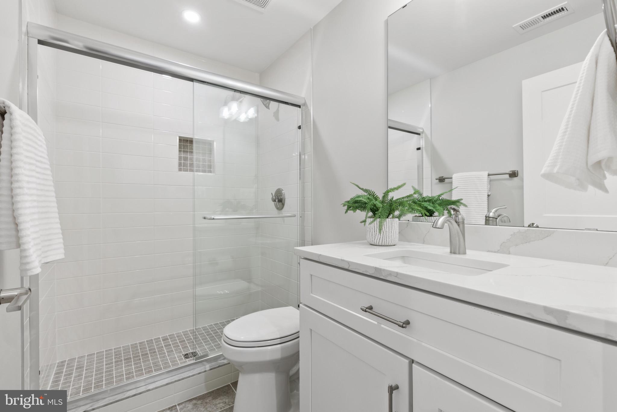1402 Mccarter Lane Edgewater, MD 21037 - Photo 25 of 30 a bathroom with a granite countertop sink a toilet and shower