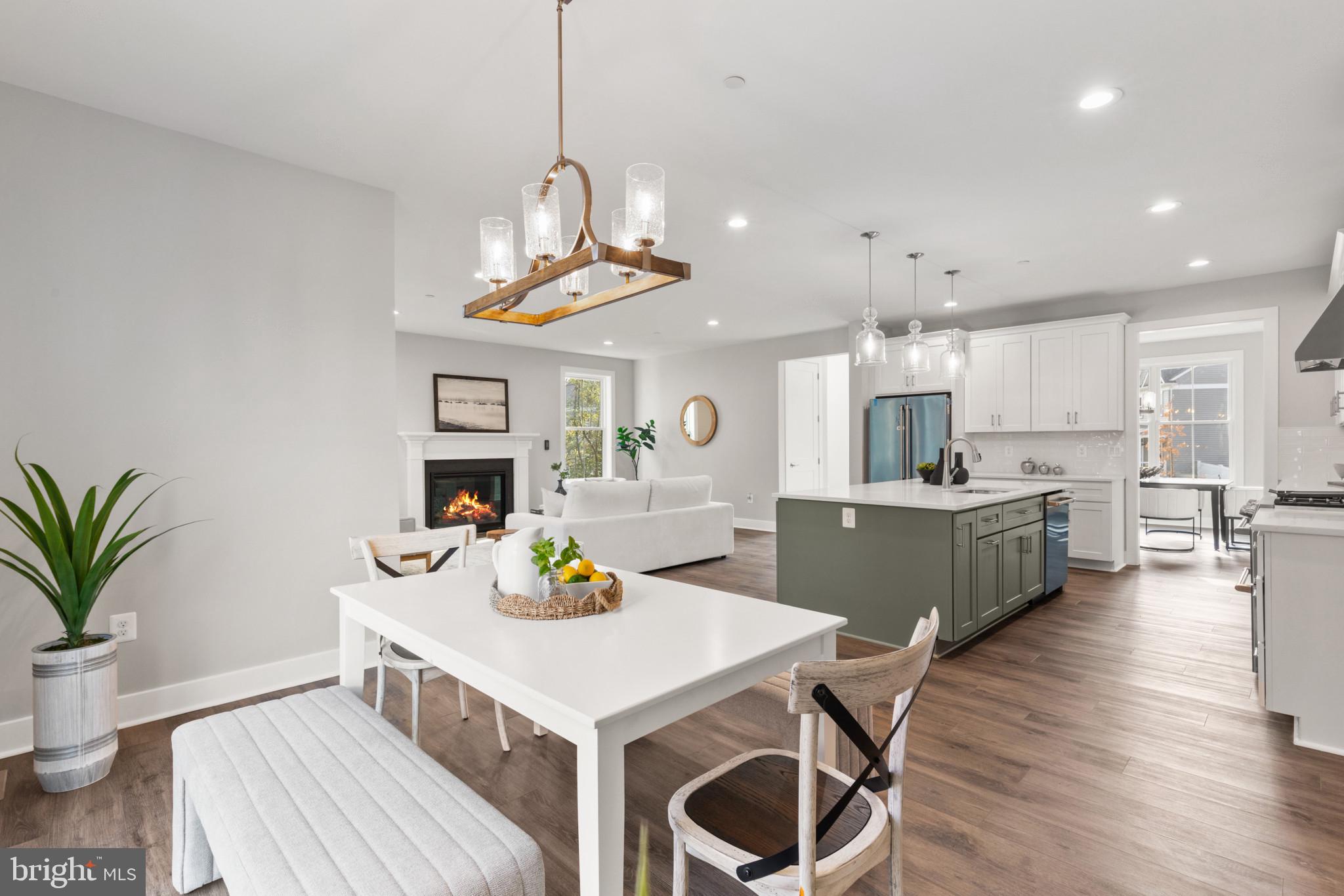 1402 Mccarter Lane Edgewater, MD 21037 - Photo 30 of 30 a kitchen with stainless steel appliances a dining table chairs and white cabinets
