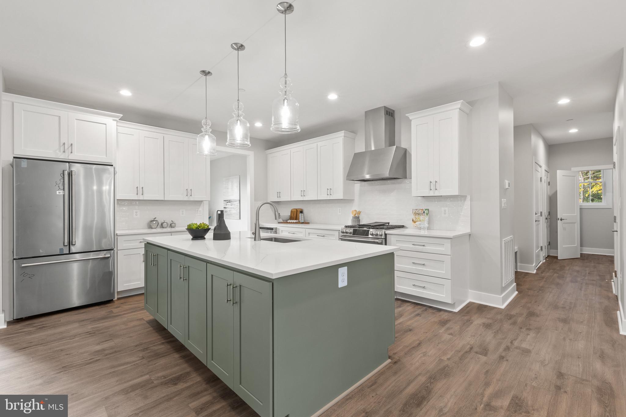1402 Mccarter Lane Edgewater, MD 21037 - Photo 4 of 30 a kitchen with kitchen island a sink stainless steel appliances and cabinets