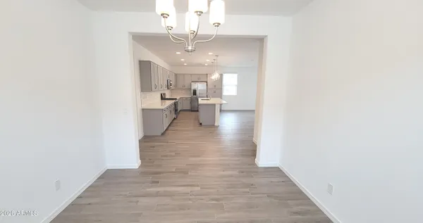 a view of a living room and kitchen with wooden floor