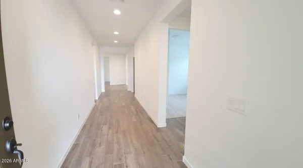a view of a hallway with wooden floor
