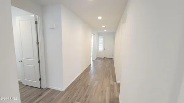 a view of a hallway with wooden floor