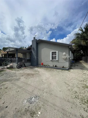 a house with trees in the background
