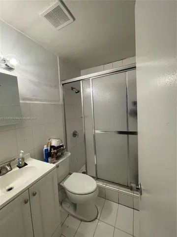 a bathroom with a toilet sink and shower