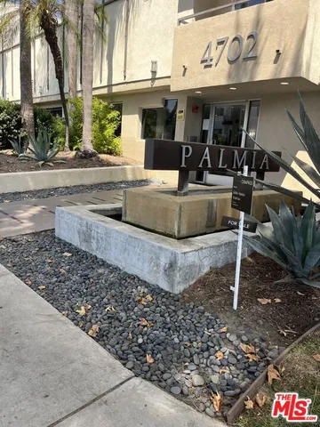 a front view of a building with garden