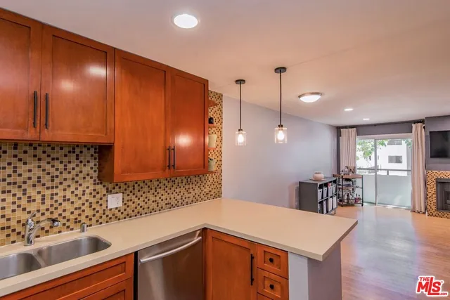 a living room with furniture a large window and a fireplace