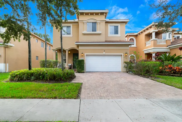 a front view of a house with a yard and garage