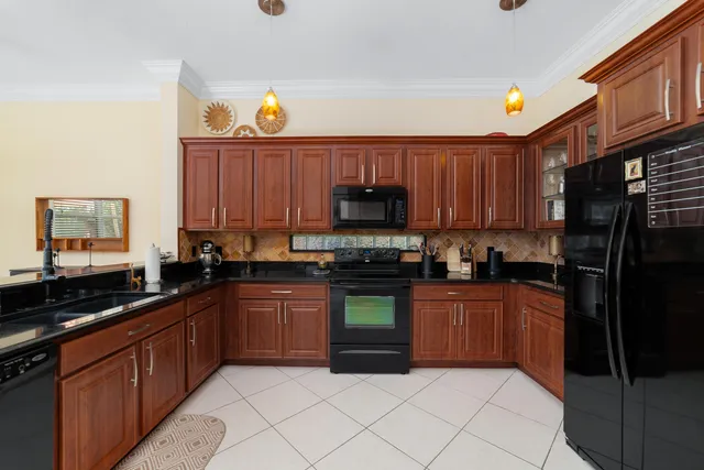 a kitchen with stainless steel appliances granite countertop a stove sink and cabinets