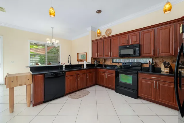 a kitchen with stainless steel appliances granite countertop a stove sink and cabinets