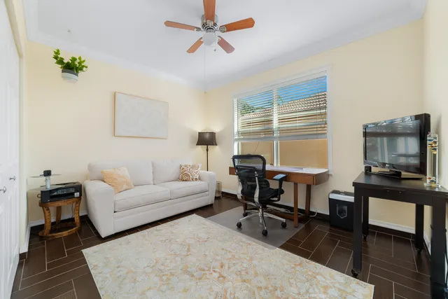 a living room with furniture a piano and a window