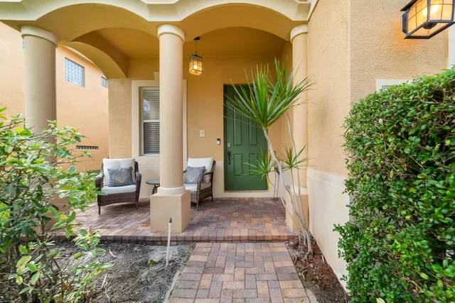 a view of a house with backyard and sitting area