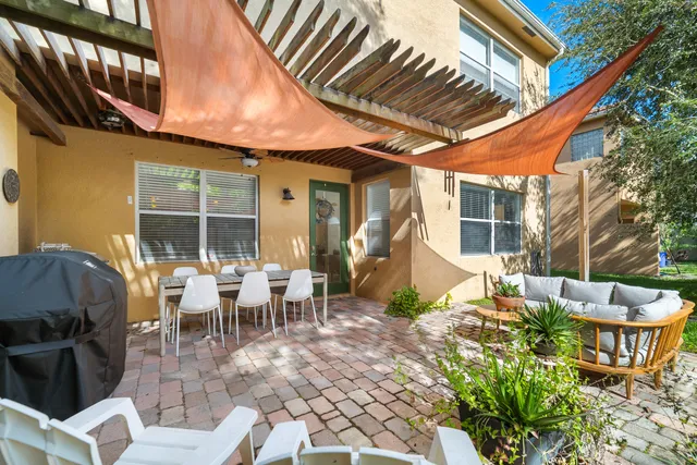 a view of a patio with table and chairs and potted plants