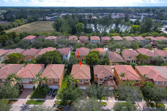 an aerial view of house with outdoor space and lake view