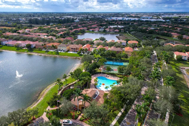 an aerial view of residential houses with outdoor space and lake view