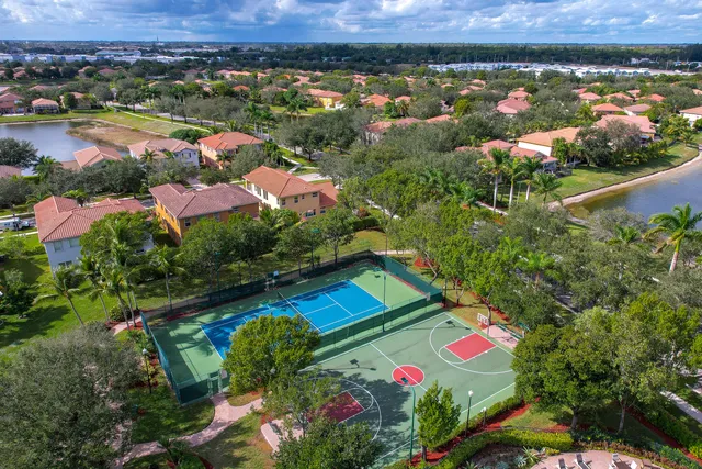 an aerial view of residential houses with outdoor space and seating