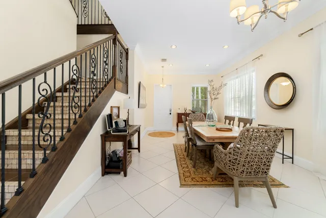 a living room with chairs and a table