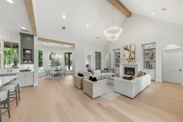a kitchen with stainless steel appliances a table chairs and a refrigerator
