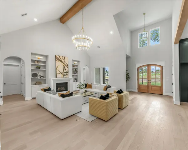 a kitchen with sink stove and white cabinets with wooden floor