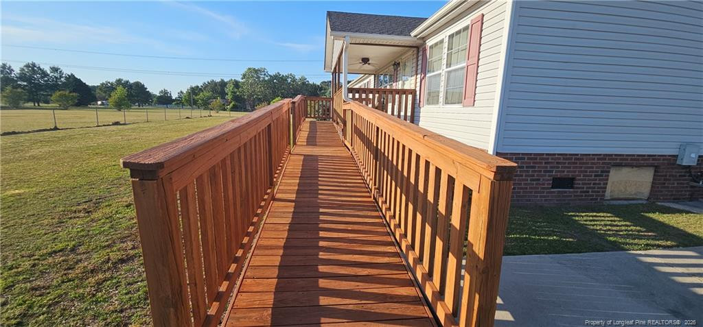 212 McIver Road Lumber Bridge, NC 28357 - Photo 9 of 28 a view of a balcony with wooden floor and lake view